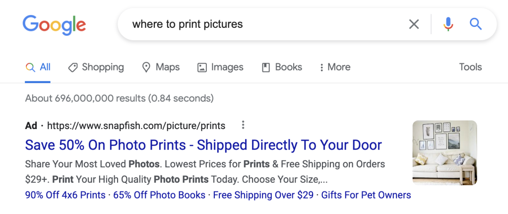 Google search results page showing an ad for Snapfish offering 50% off photo prints.